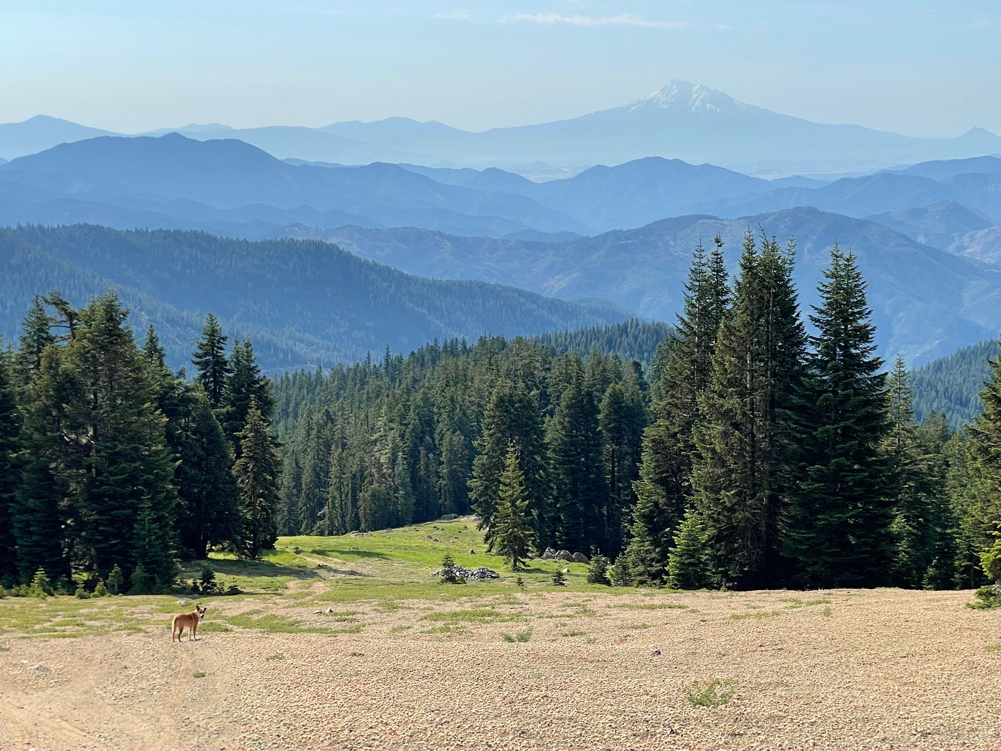 Distant snow-capped peak over layered Southern Oregon mountain ridges